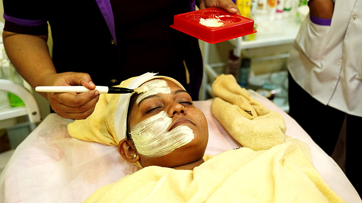 Facial treatment in progress at beauty training session.