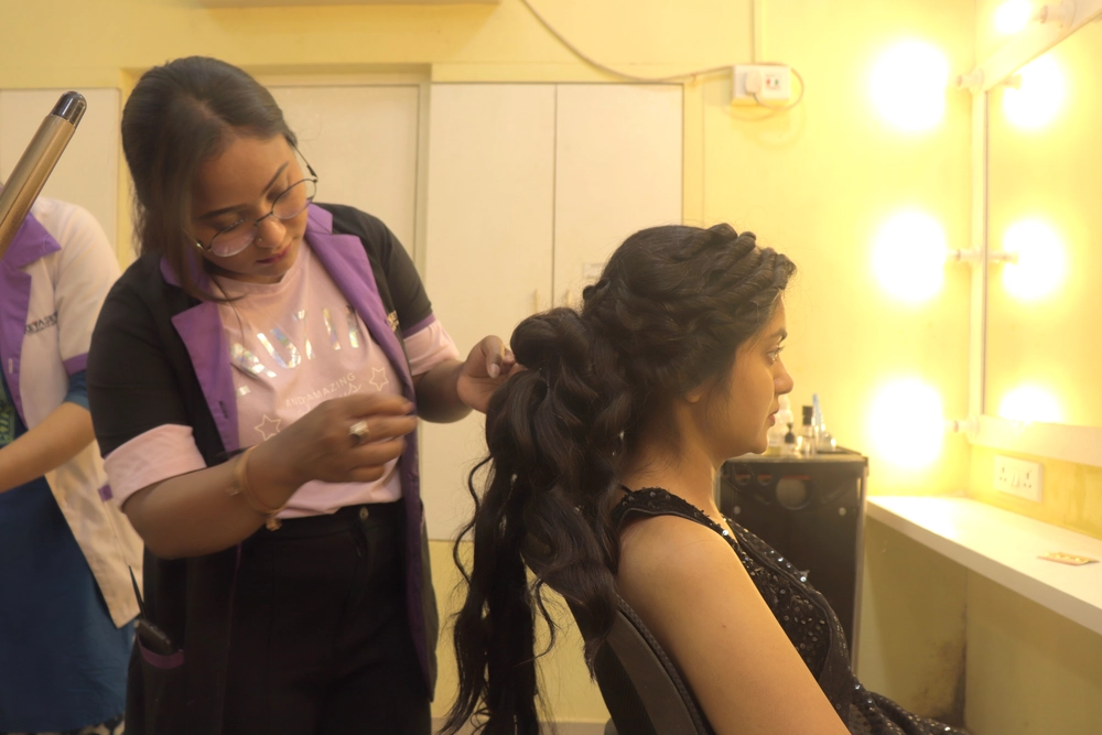 Hair styling session in progress with student working on client's hair.